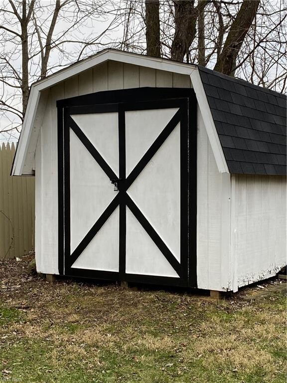Storage shed in fenced in back yard also has new r