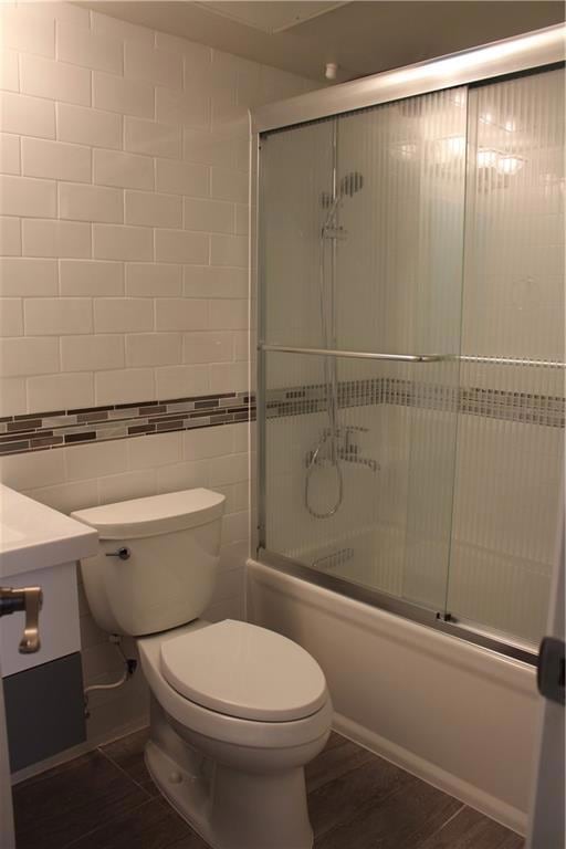 Bathroom featuring enclosed tub / shower combo, v
