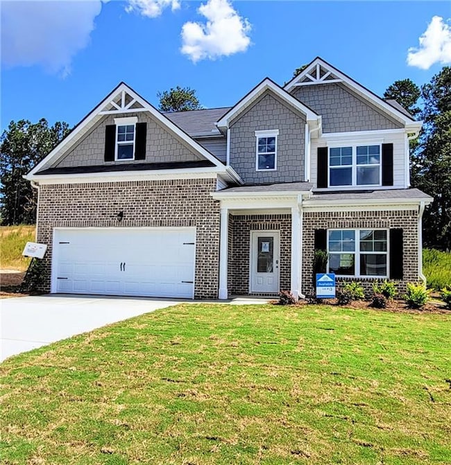 Craftsman-style house featuring concrete driveway, a garage, a front lawn, brick siding, and covered porch-Actual Home