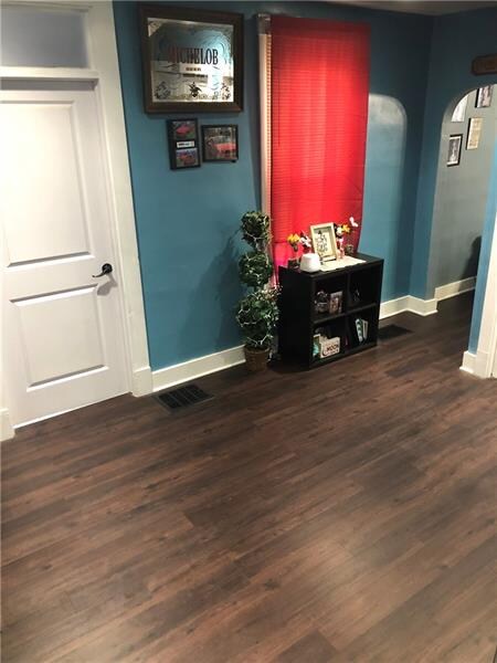 Dining room has new dark laminate wood flooring.