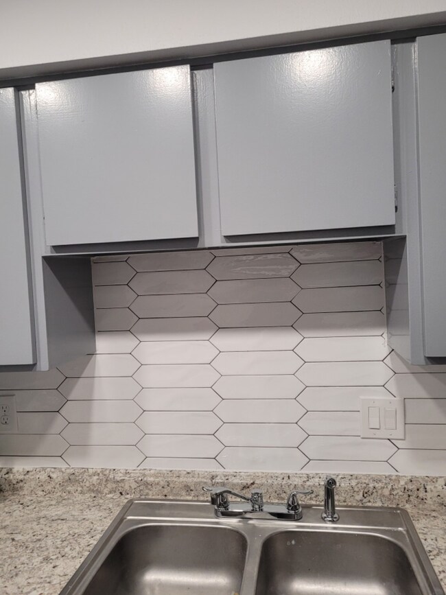 Ceramic tile backslash in kitchen,  recessed light
