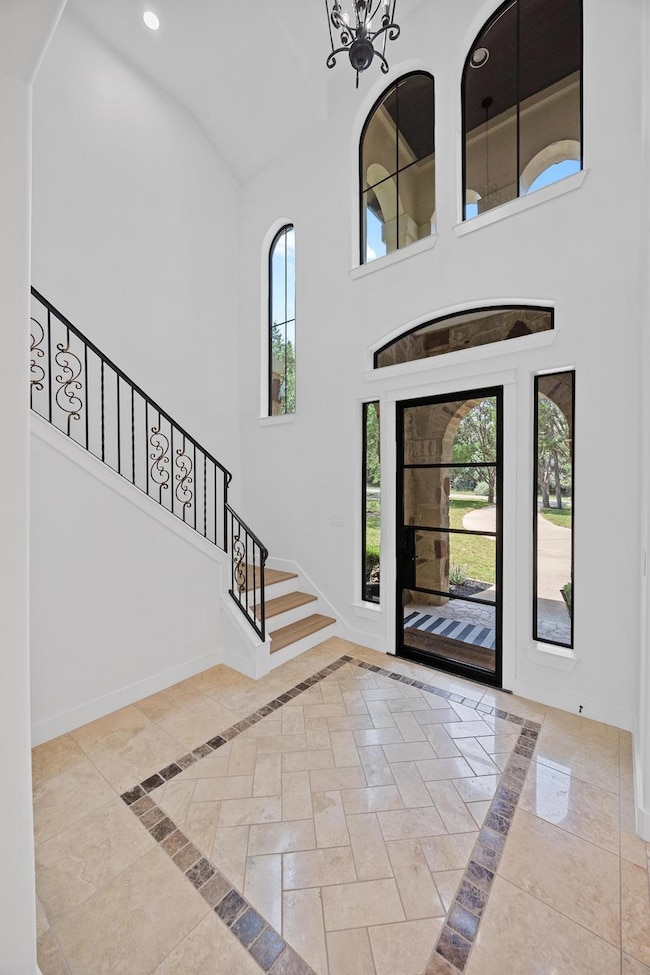 Foyer featuring inlaid floor details, plenty of n
