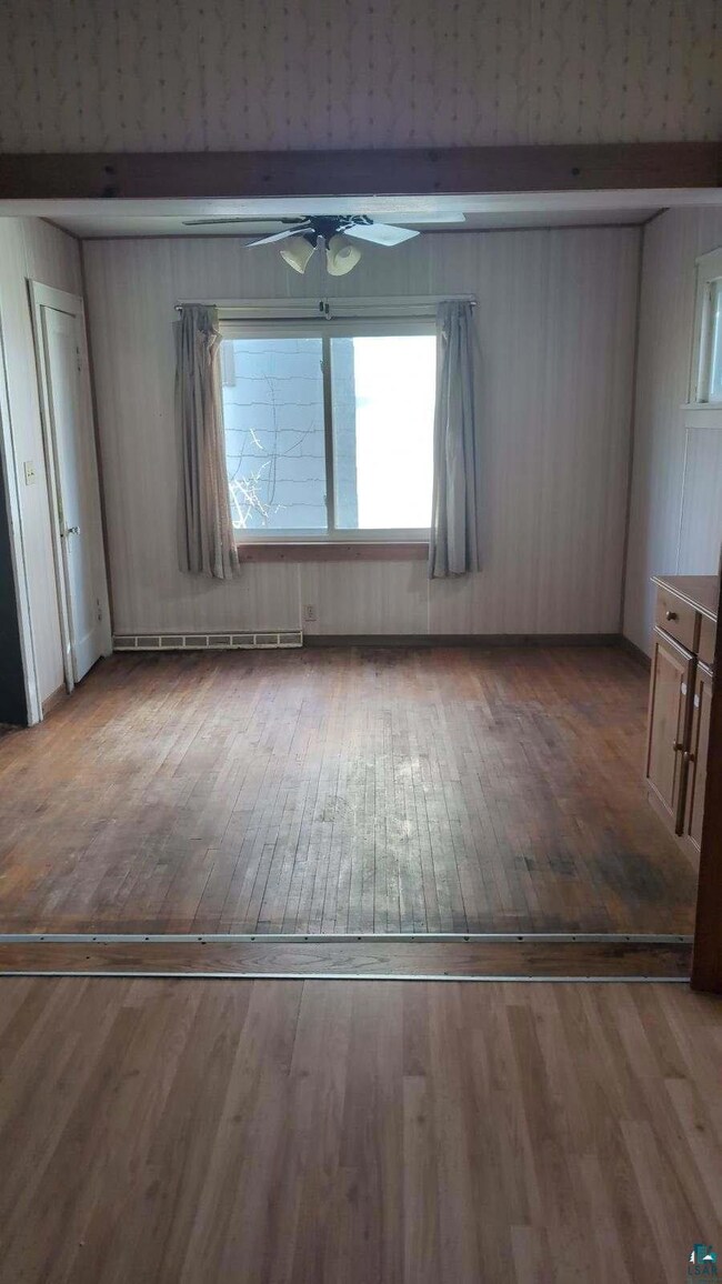Unfurnished room featuring dark wood-type flooring