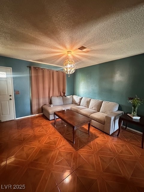 Living room with baseboards, a chandelier, visible