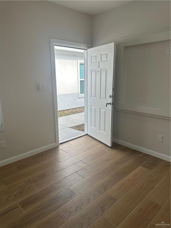 Foyer with wood finished floors and baseboards