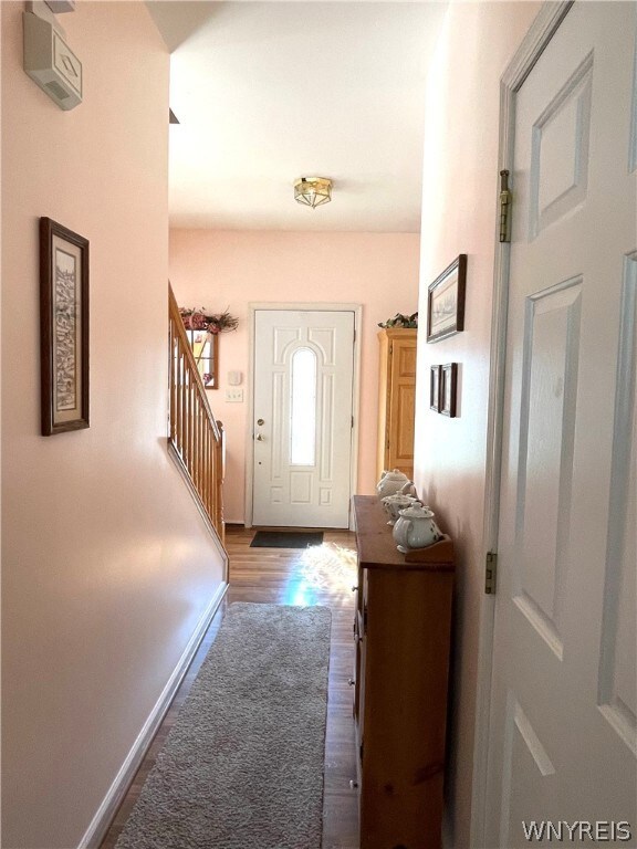 foyer hall leads to 1/2 bath and family room