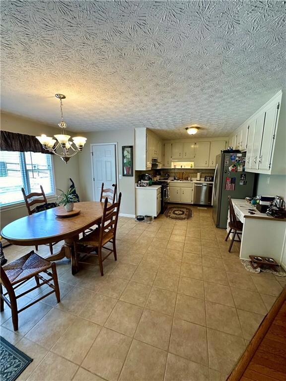 Tiled dining area with a textured ceiling and a no