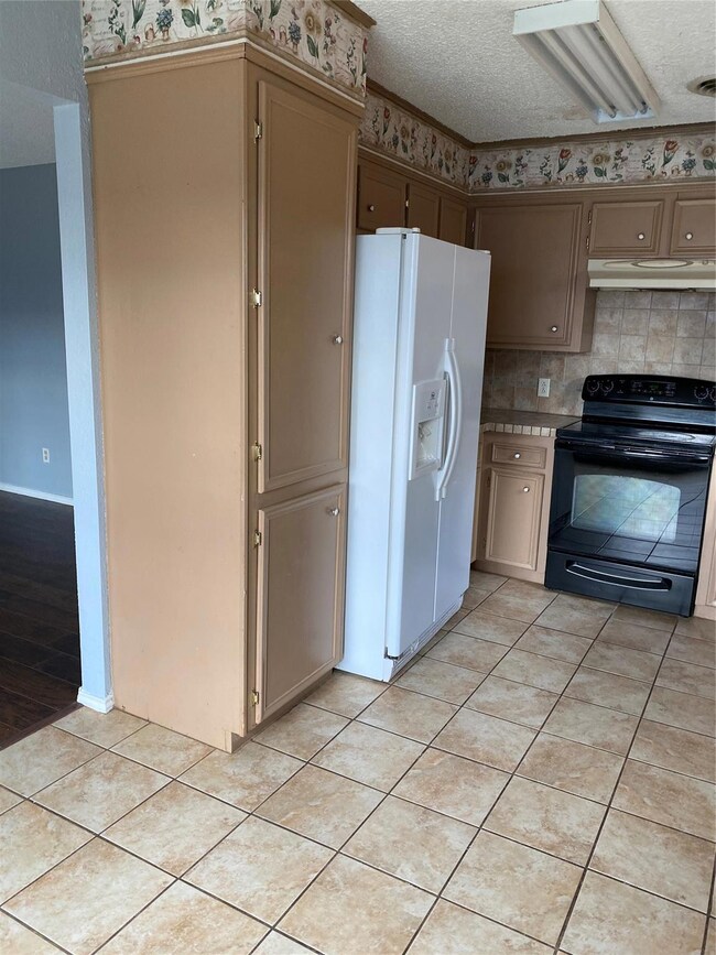 Kitchen featuring range hood, light wood-type floo