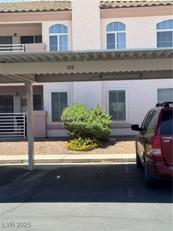 View of property featuring covered parking