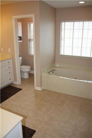 Newly installed tile floor and new light fixtures.  Dual vanities & separate walk-in shower and whirlpool spa tub.  