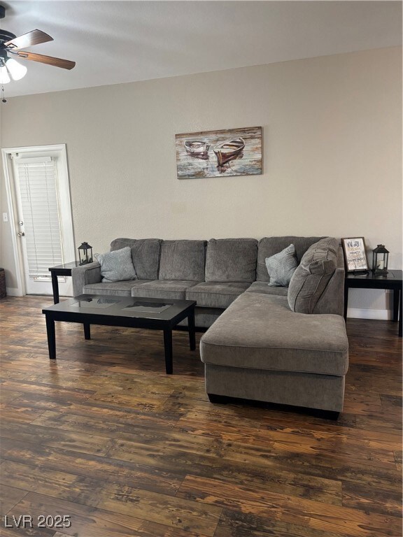 Living area featuring a ceiling fan and wood-type