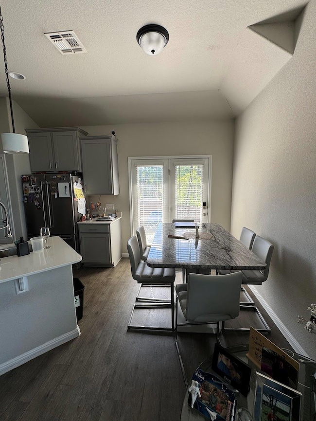 Dining space with dark wood finished floors, base