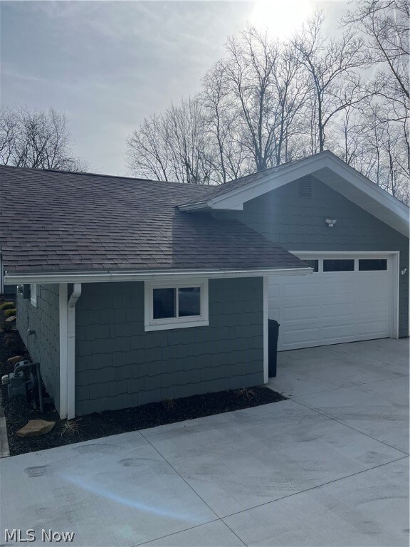 View of property exterior featuring a garage