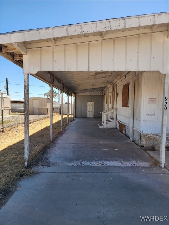 View of vehicle parking featuring a carport