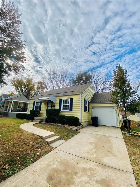 Ranch-style home featuring concrete driveway, an attached garage, and roof with shingles