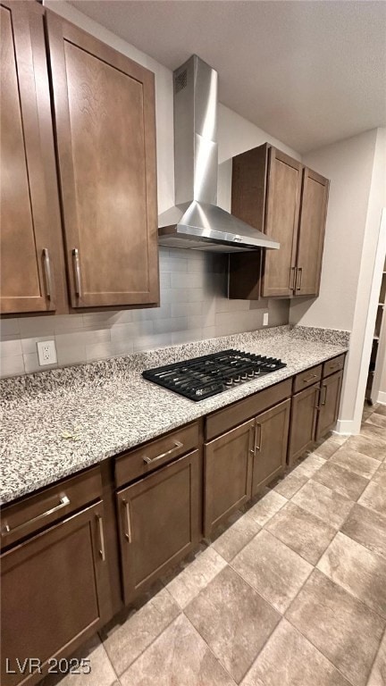 Kitchen featuring light stone counters, stainless