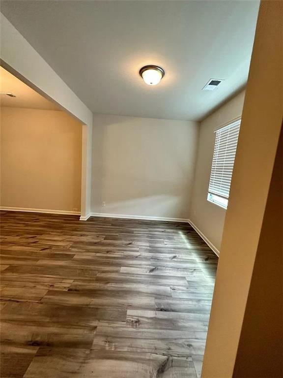 Empty room with wood finished floors and baseboards