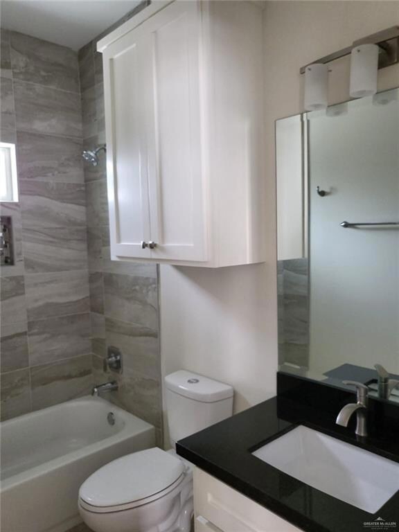 Full bath featuring toilet, tub / shower combination, and vanity