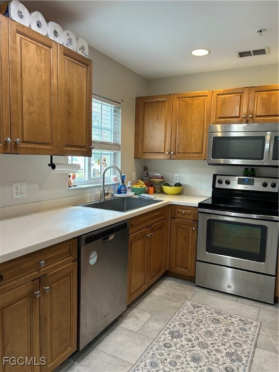 Kitchen with stainless appliances, large sink, Corian counter tops.