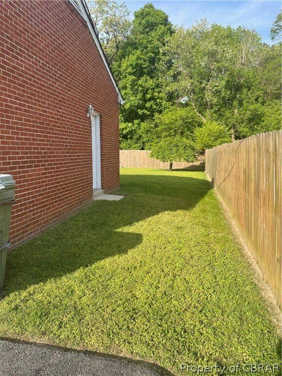 Right Side yard, shows the garage pedestrian door