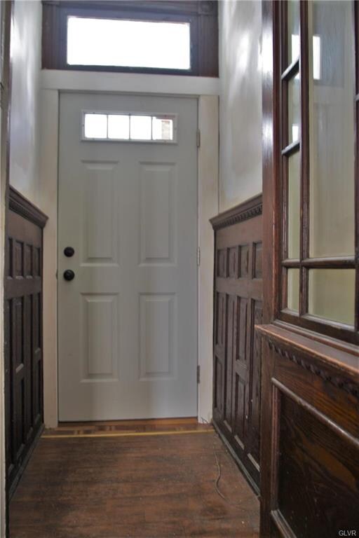 Beautiful wood-trimmed foyer with double doors to 