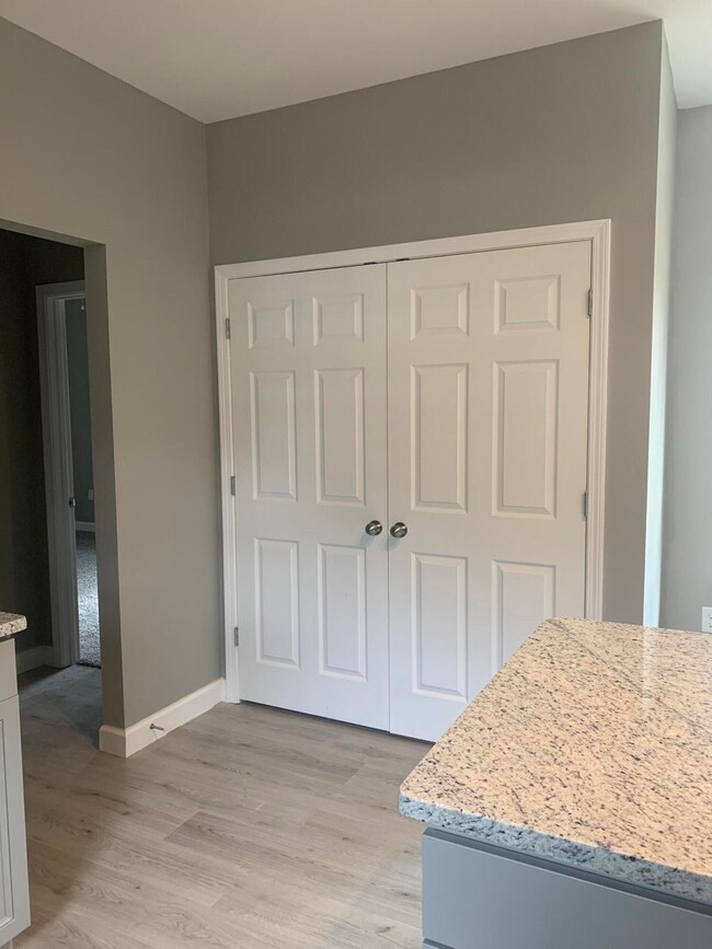 Washer dryer closet off kitchen.