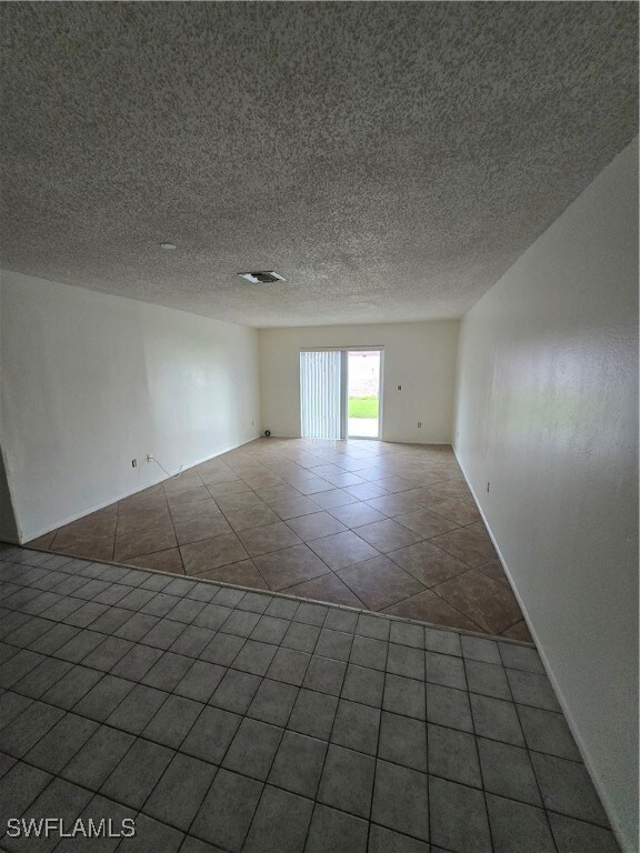 Empty room featuring tile patterned flooring and a