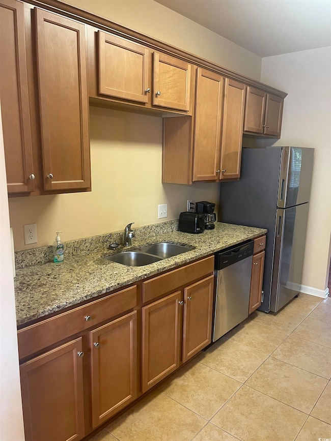 Kitchen featuring dishwasher, sink, light stone co