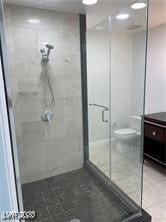 Full bathroom with vanity, a stall shower, and tile patterned floors