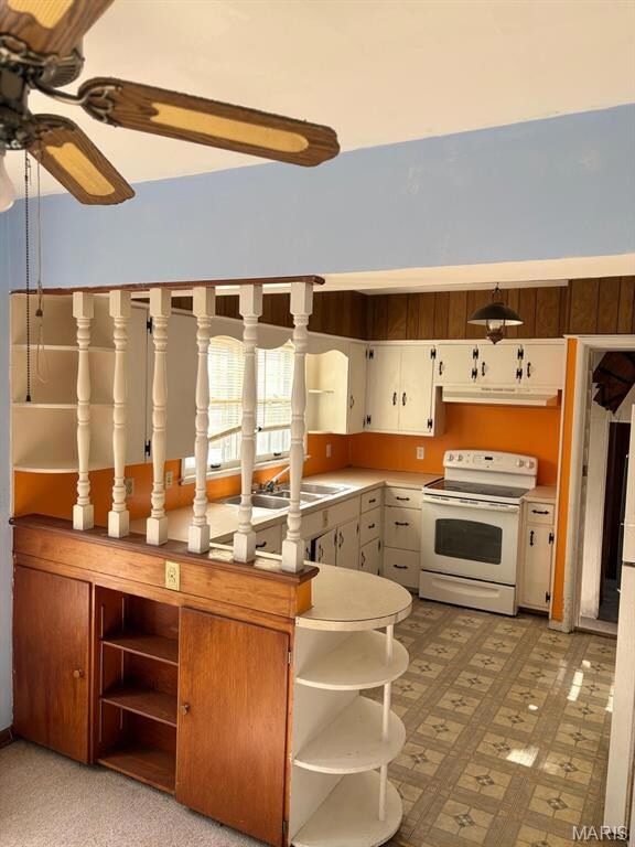 Kitchen featuring white electric range, light countertops, open shelves, light flooring, and a ceiling fan