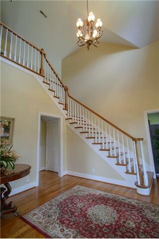 Grand staircase looking from dining room entry.