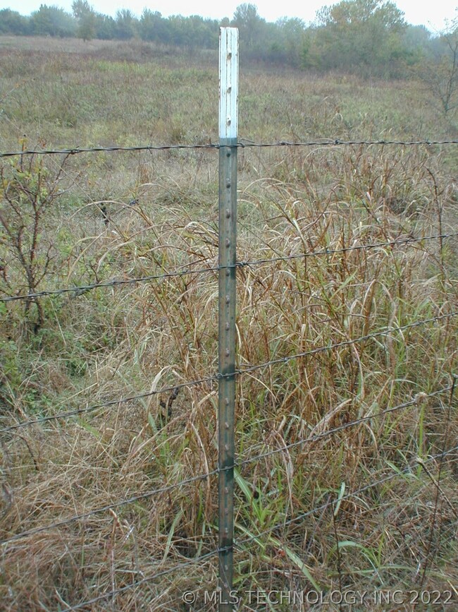 BARBED WIRE FENCE IS AROUND 20 OF THE 21.97 ACRES.