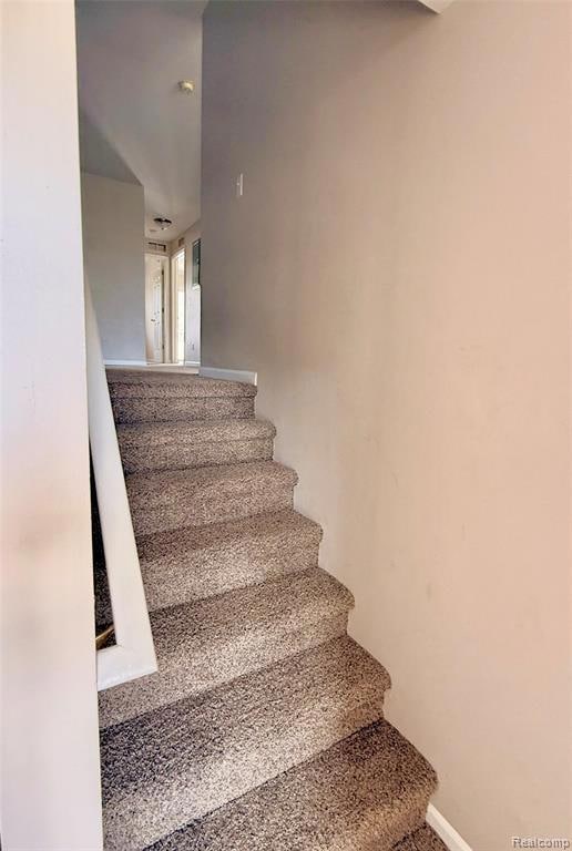 Staircase featuring baseboards