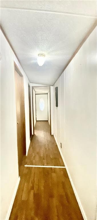 Corridor featuring carpet floors and baseboards