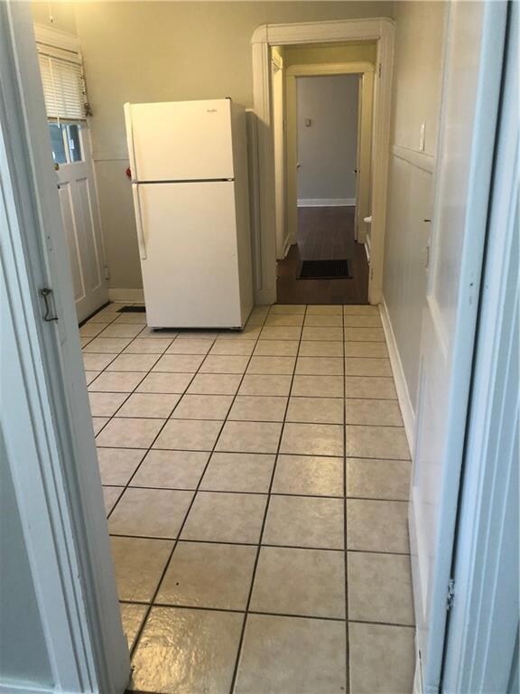 There is a door separating Bedroom 1 to Kitchen wi