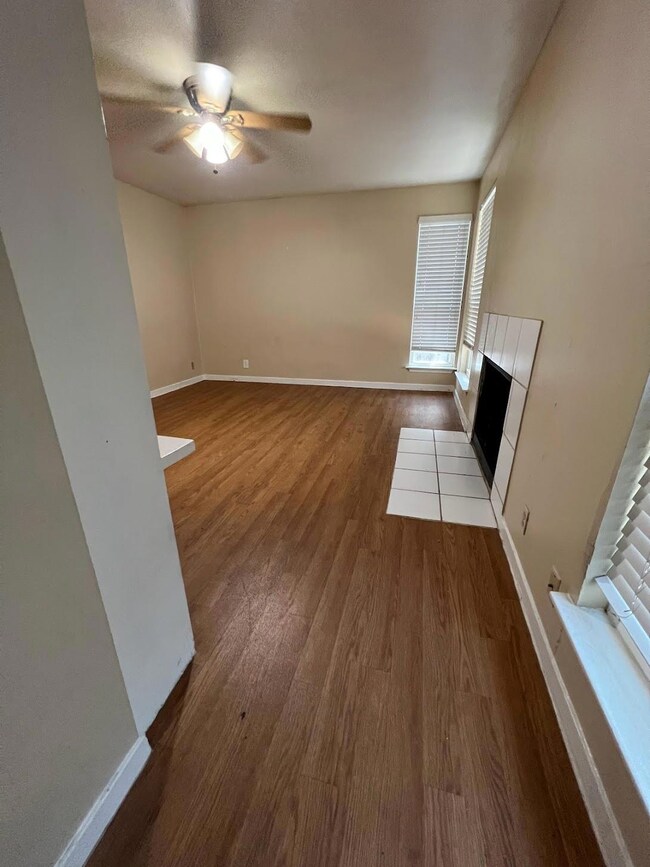 Unfurnished living room featuring baseboards, a c