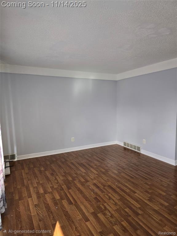 Family room with dark wood-style floors and a textured ceiling