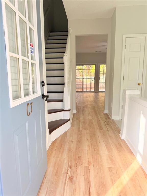 Entrance foyer featuring light wood-style flooring and stairway
