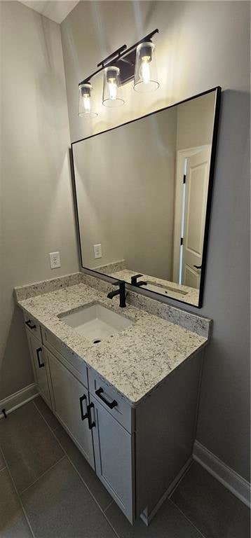 Bathroom featuring tile patterned flooring, vanity