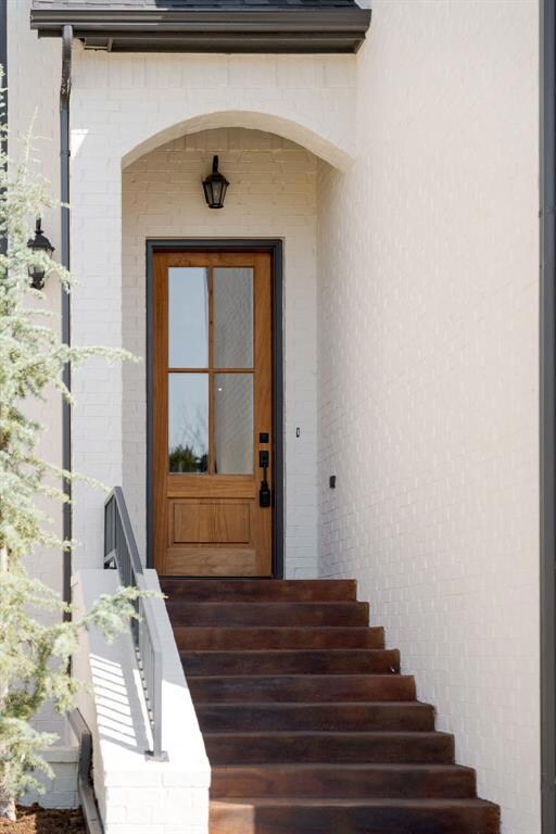 Front door with stained concrete steps