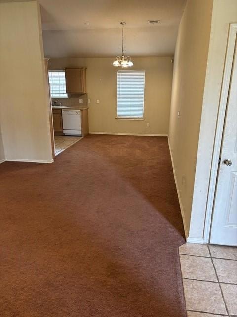Unfurnished dining area featuring light carpet and a chandelier