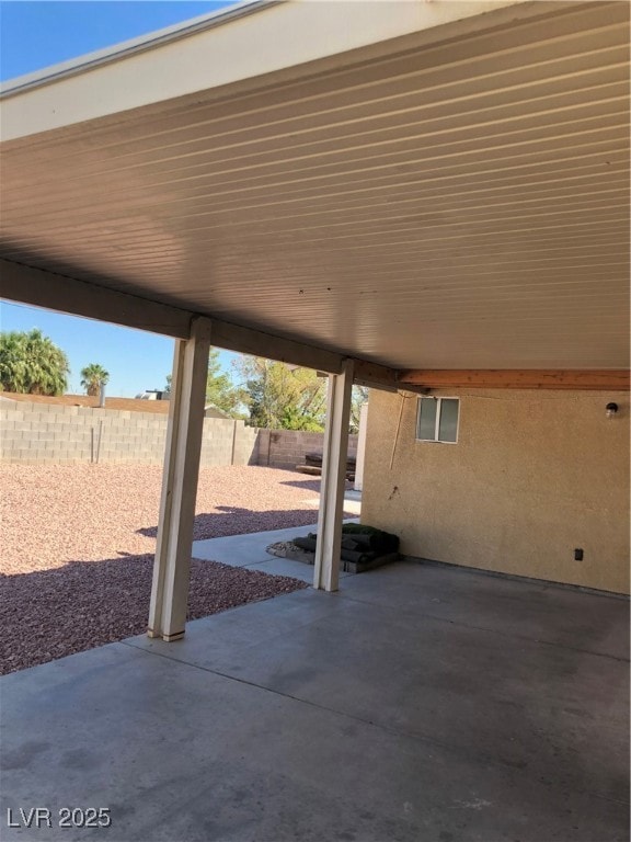 Fenced backyard with a patio