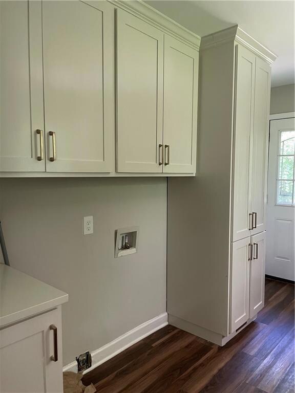 Laundry area in kitchen featuring cabinet space