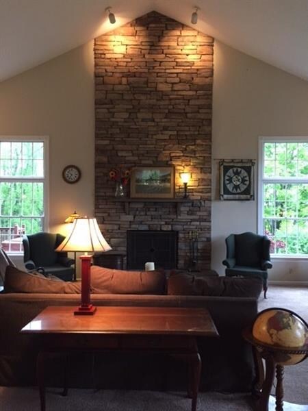 Newer great room with vaulted ceilings and floor t