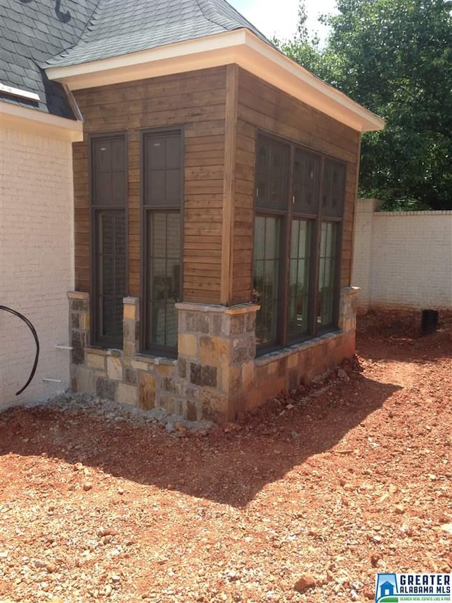 A combination of rock, lap cedar, and oversized wi