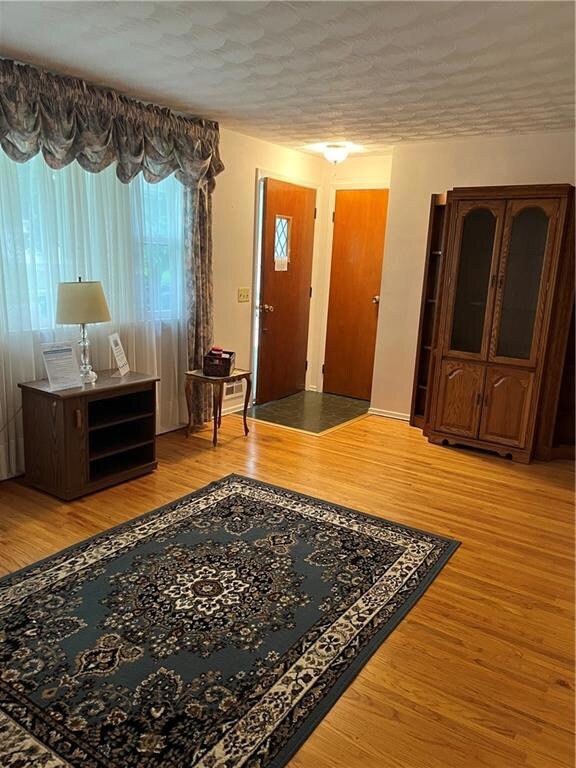 Nice entry- way with coat closet welcomes you into the family room with hard wood flooring & neutral painted walls!