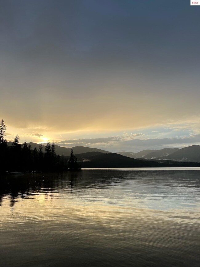 With serene panoramic lake and mountain views