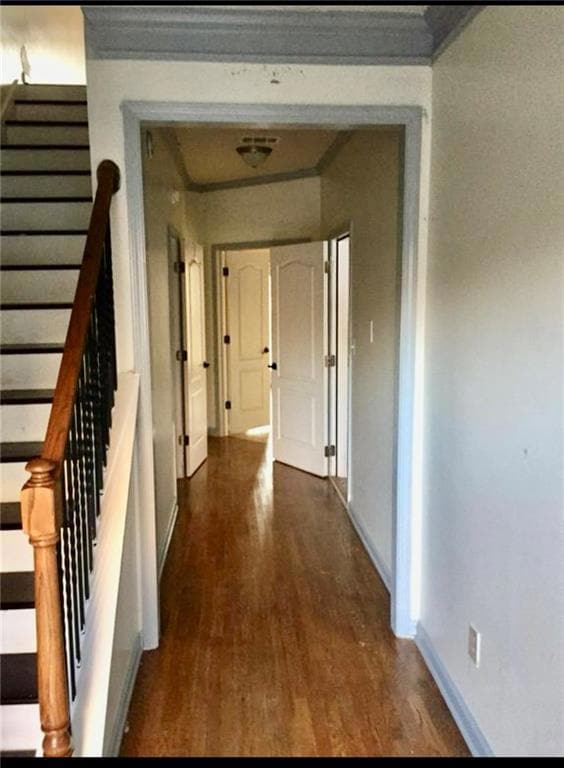 Hallway featuring dark wood-style floors and stairway