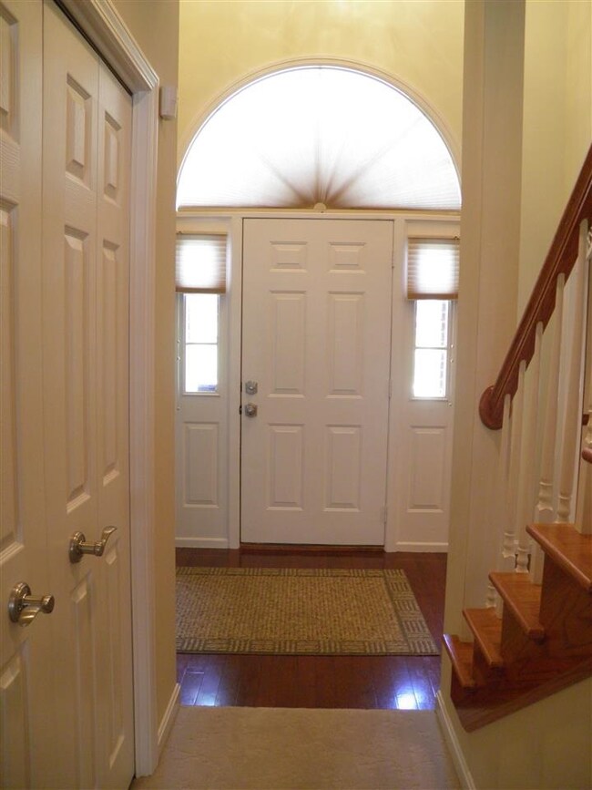 Beautiful two story foyer with pretty hardwood flo