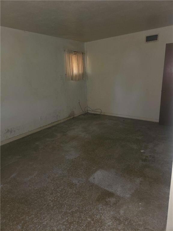 Unfurnished room with baseboards